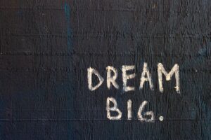 black background with text in white saying DREAM BIG.